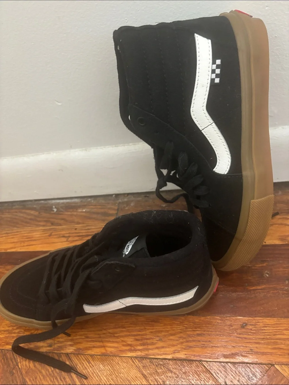 Black canvas vans hightops with brown rubber soles and white logo+ racing detail